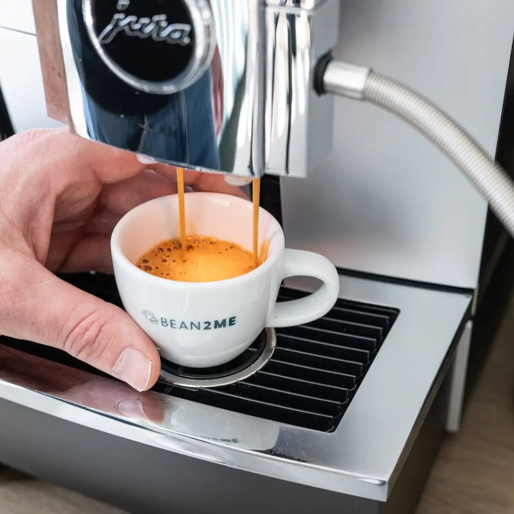 Espresso pouring from a rented JURA machine at a Bean2me client